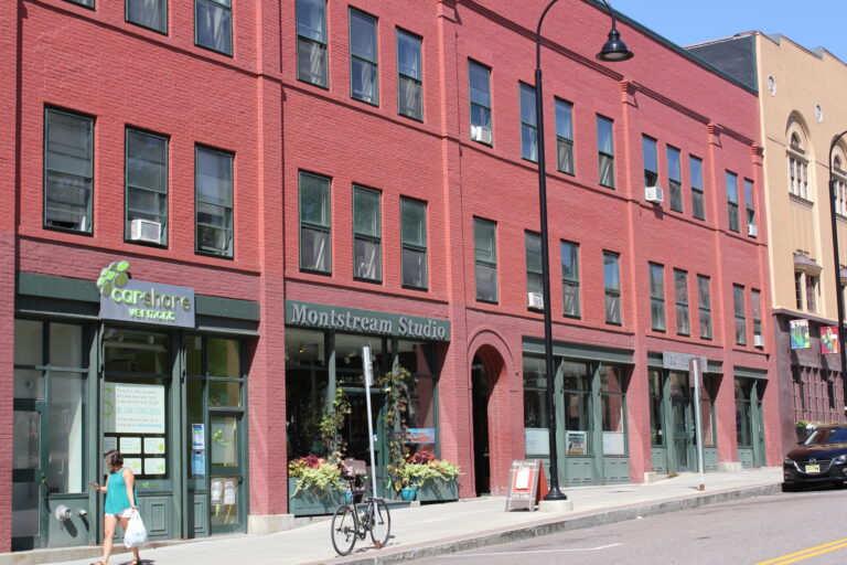 St. Paul street view of a red brick building and storefronts